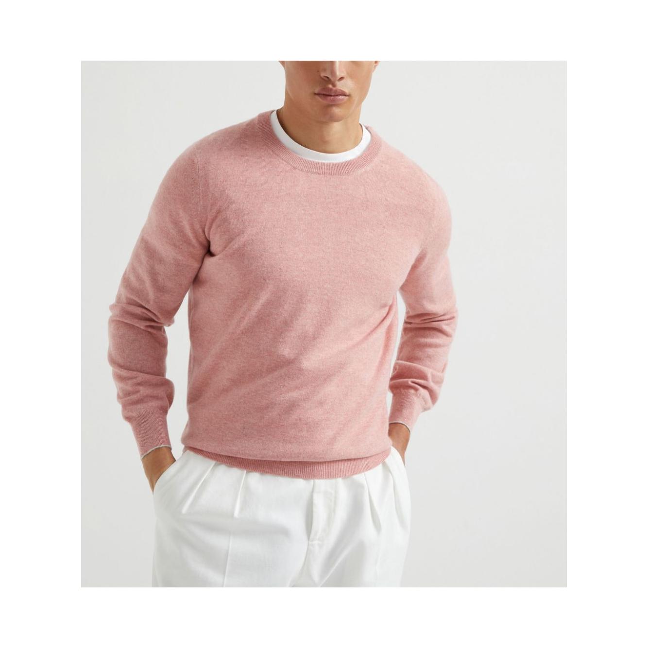 Light pink Brunello Cucinelli cashmere crewneck sweater with ribbed cuffs and hem, model wearing size 48 over white pants.