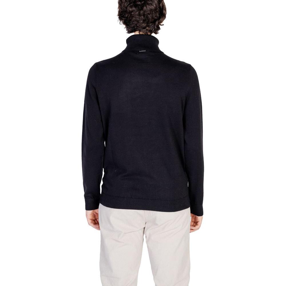 Back view of a man wearing an Antony Morato black cotton sweater, part of the men's fall/winter knitwear collection, 90% cotton, 10% wool.