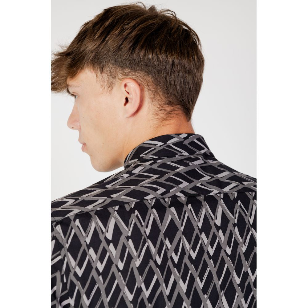 Back view of a man wearing an Antony Morato black cotton shirt with geometric pattern, from Fall/Winter collection.
