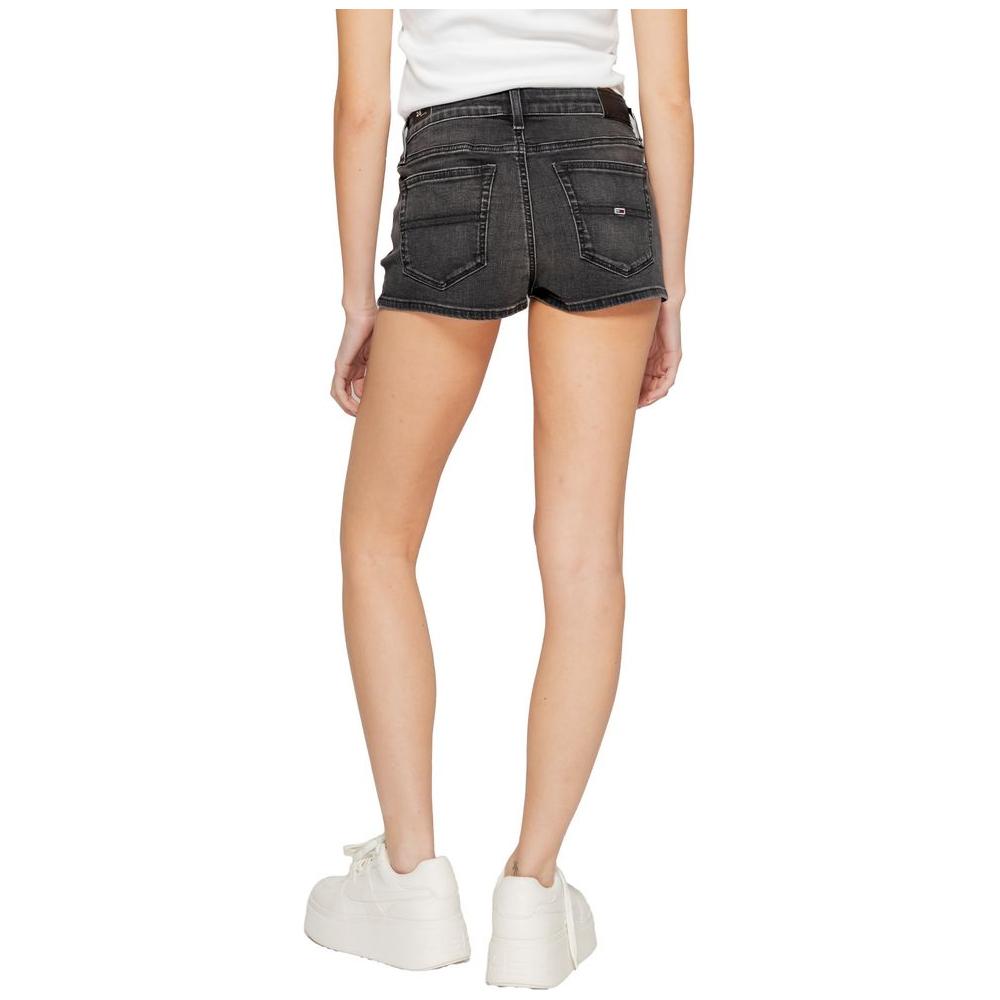 Back view of woman wearing Tommy Hilfiger black recycled cotton denim shorts and white sneakers
