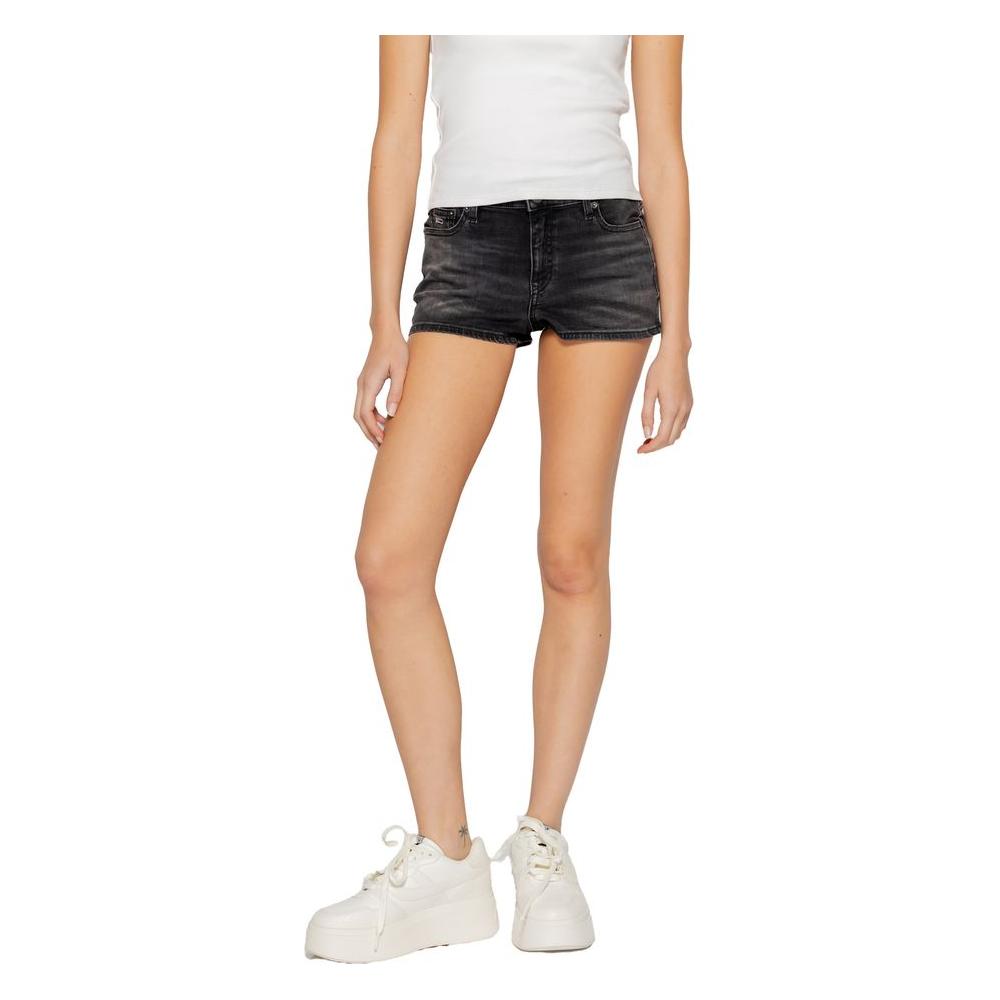 Model wearing black Tommy Hilfiger women's shorts made from recycled cotton, available in spring/summer collection.
