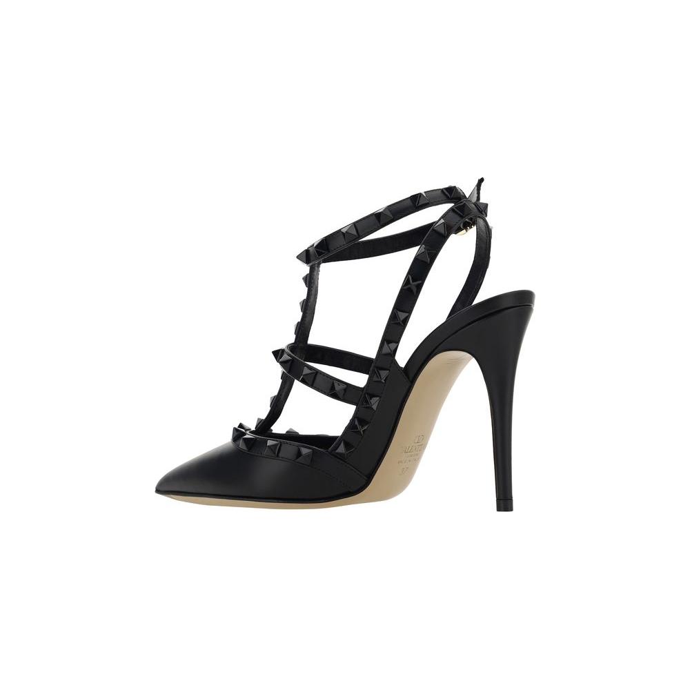 Valentino Garavani Rockstud Pumps - Black leather with geometric toe, adjustable ankle strap, stiletto heel, and iconic studs.