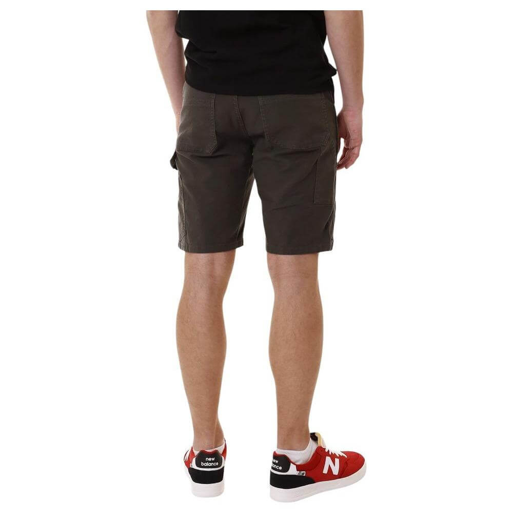 Back view of person wearing Lyle & Scott men's green cotton shorts, fall/winter collection, paired with sneakers.