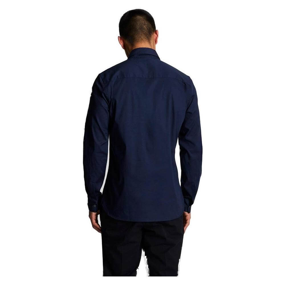 Back view of a man wearing a Lyle & Scott blue long-sleeve cotton shirt from the Fall/Winter collection, featuring an elegant design.