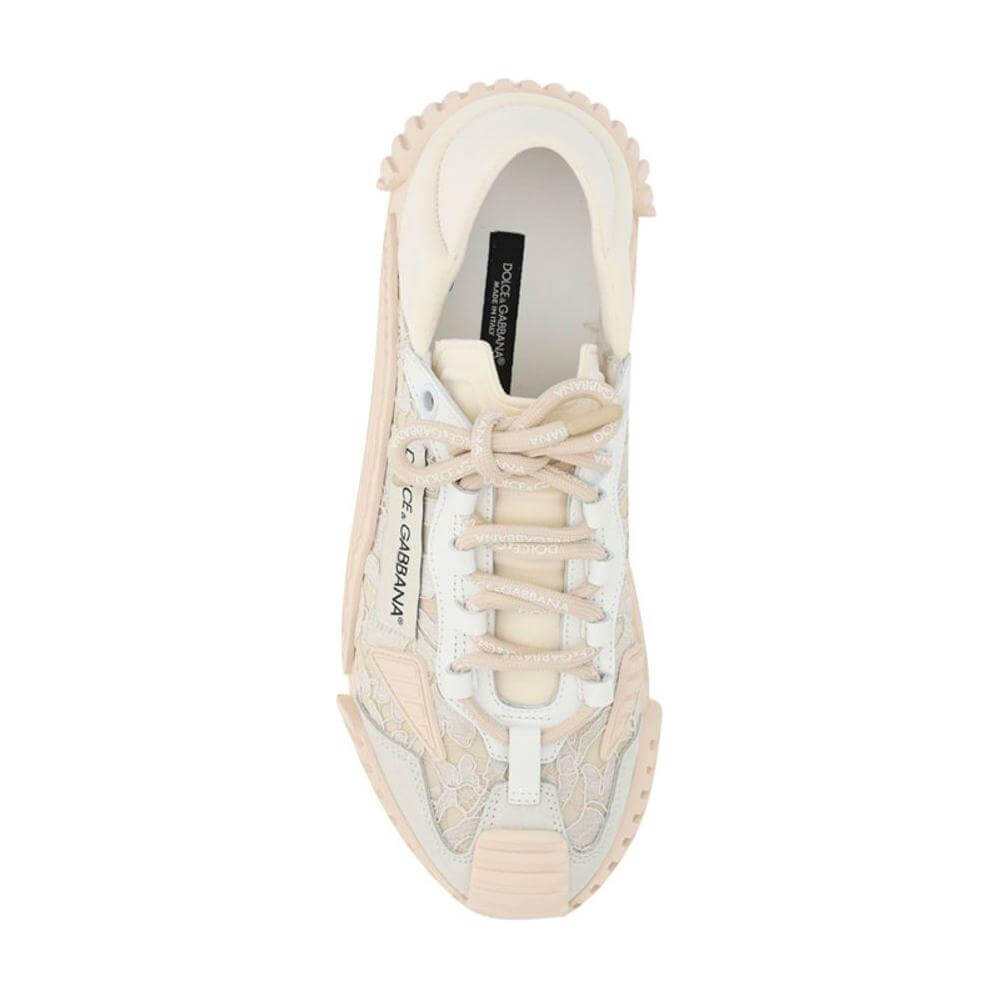 Dolce & Gabbana sneakers with textured rubber sole, lace-up closure, and branded monogram on the side panel, top view.