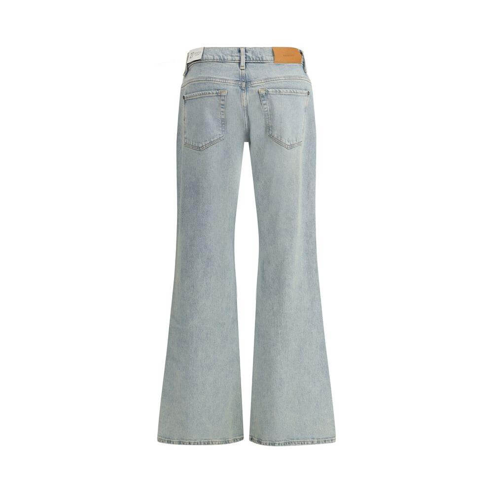 Back view of 7For Spencer Flare Sahara Jeans in light wash, featuring flared legs and signature leather patch on the waistband.
