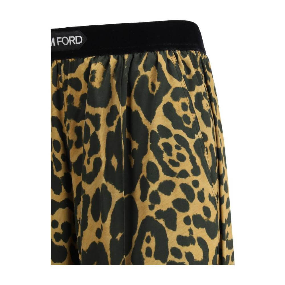 Tom Ford silk pants with animal print and contrasting elastic waistband, featuring side and back pockets for stylish functionality.
