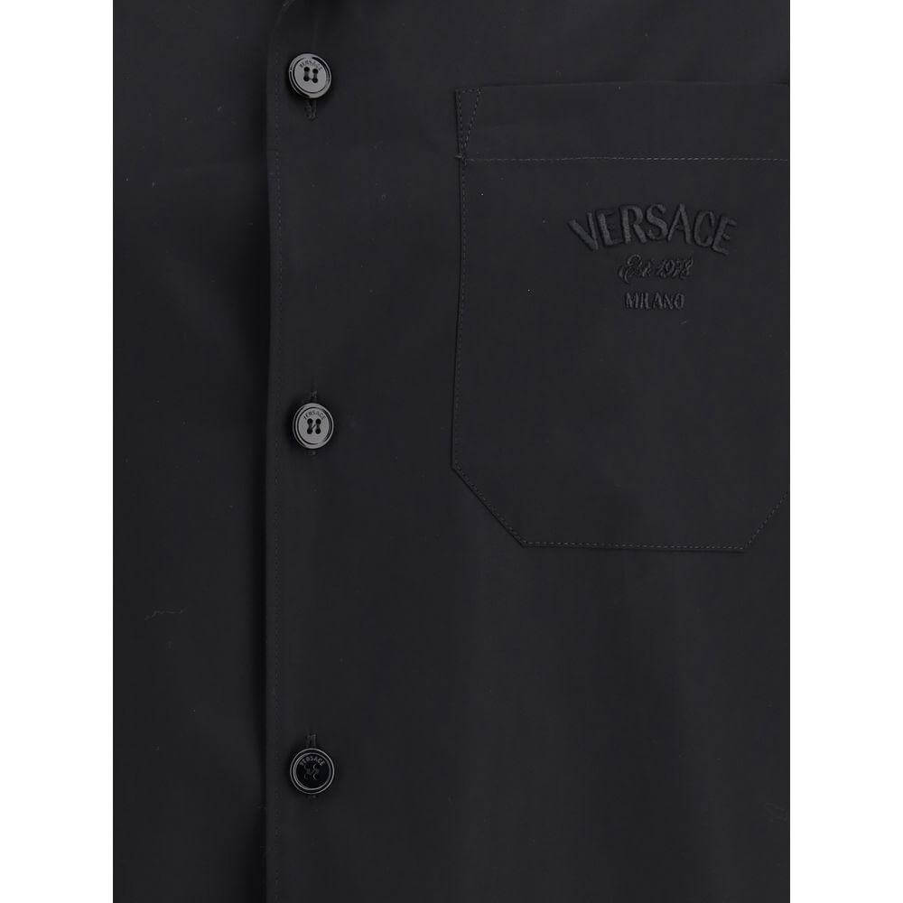 Versace Medusa pattern short-sleeved cotton shirt with classic collar and front patch pocket, featuring iconic logo. Elegant summer wear.