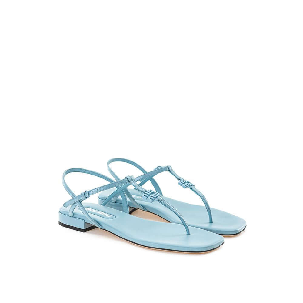 Miu Miu Blue Patent Leather Sandal, square toe, T-style, logo lettering, contrasting black heel, 100% leather composition.
