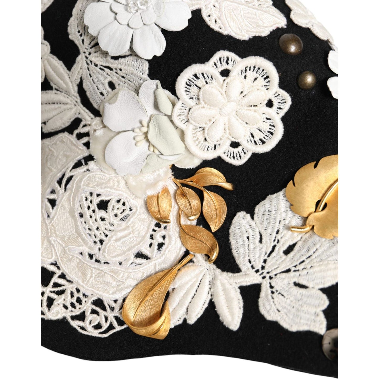 Dolce & Gabbana black cloche hat with white floral embroidery, gold leaf accents, and silk lining, inspired by Sicilian motifs.