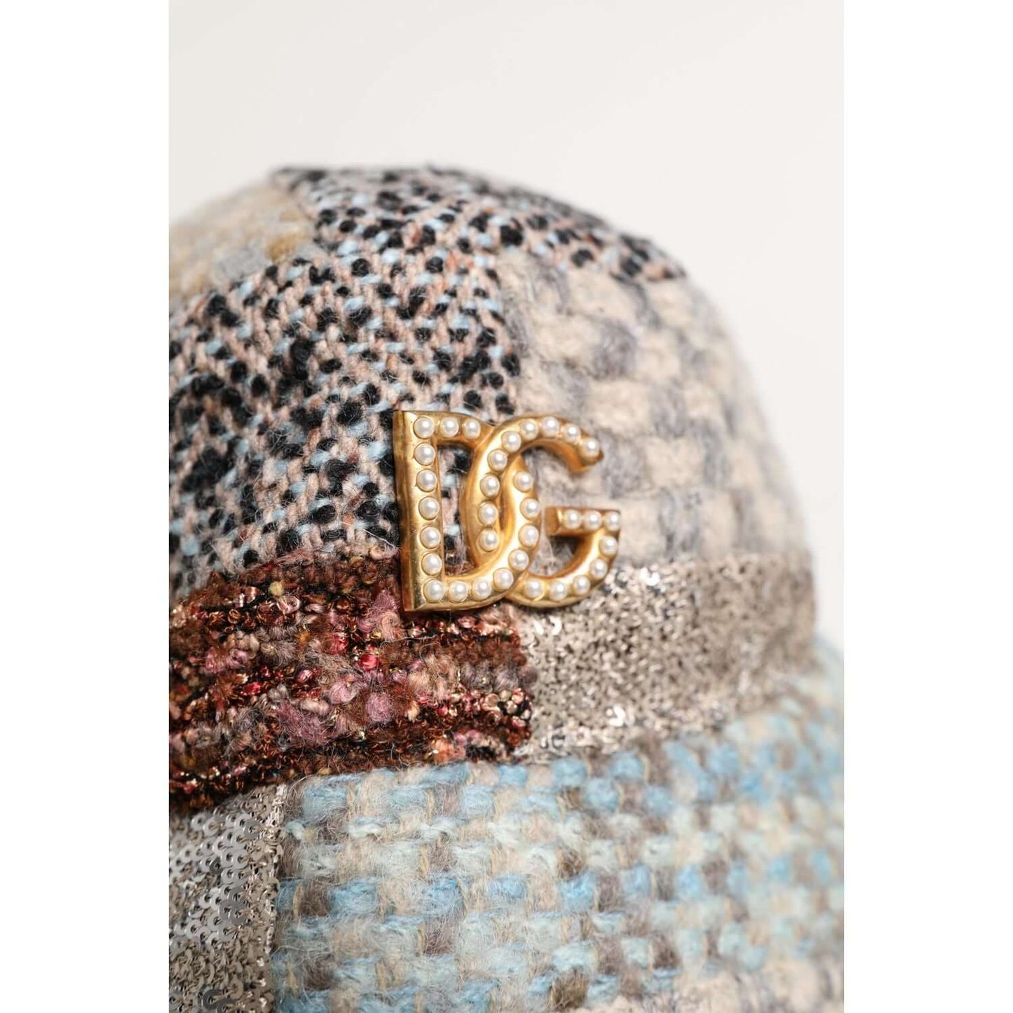 Dolce & Gabbana multicolor patchwork bucket hat with pearl DG logo, made in Italy, close-up view.