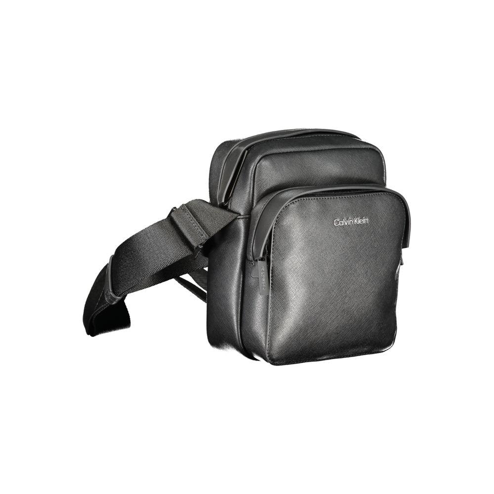 Calvin Klein black polyester shoulder bag with adjustable strap, external and internal pockets, zip closure, and logo detail.