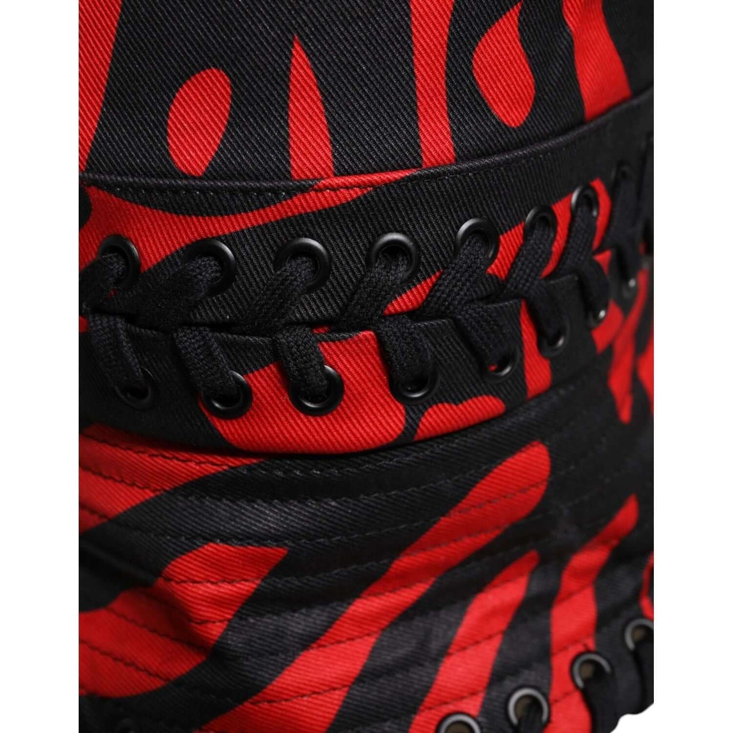 Dolce Gabbana bucket hat with red black stripe design, black eyelets, lace detail, made of 100% polyester, close-up view.