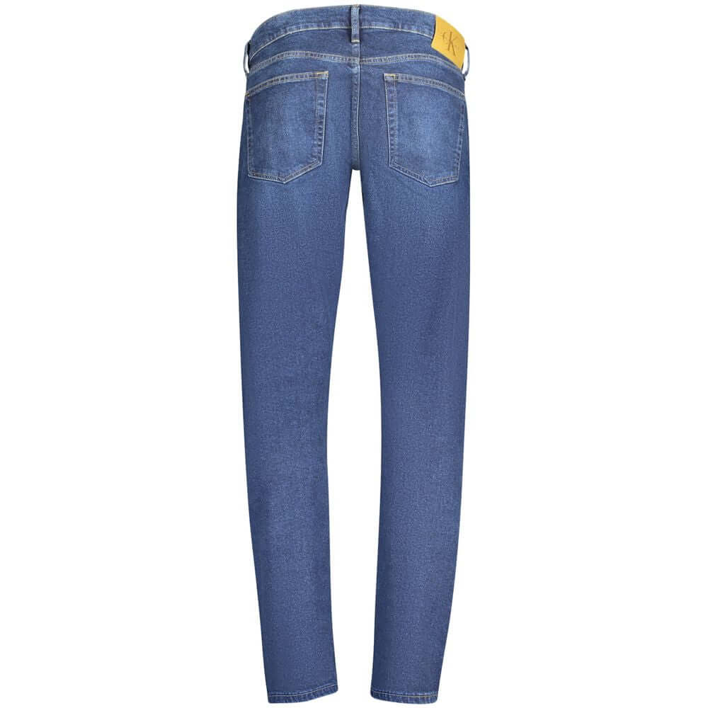 Back view of Calvin Klein blue cotton men's slim tapered jeans with five pockets and iconic logo.