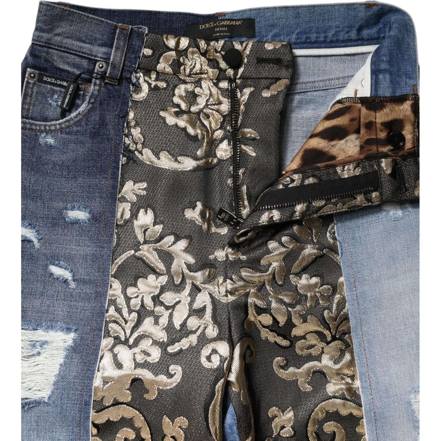 Dolce & Gabbana multicolor patchwork high waist jeans with floral jacquard, close-up view. Made in Italy, button and zipper closure.