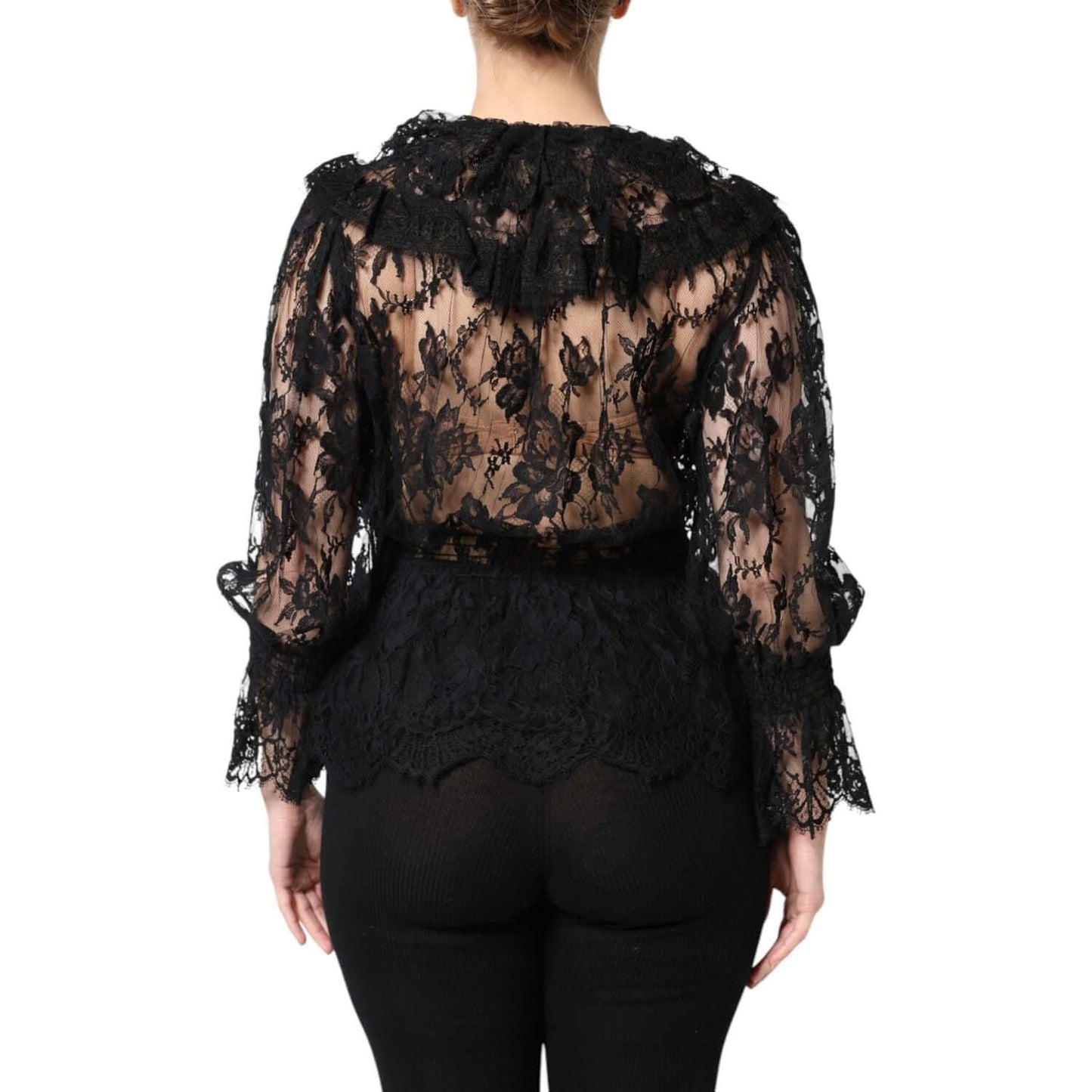 Back view of a black floral lace Dolce & Gabbana blouse with long sleeves and intricate design, showcasing luxury craftsmanship.