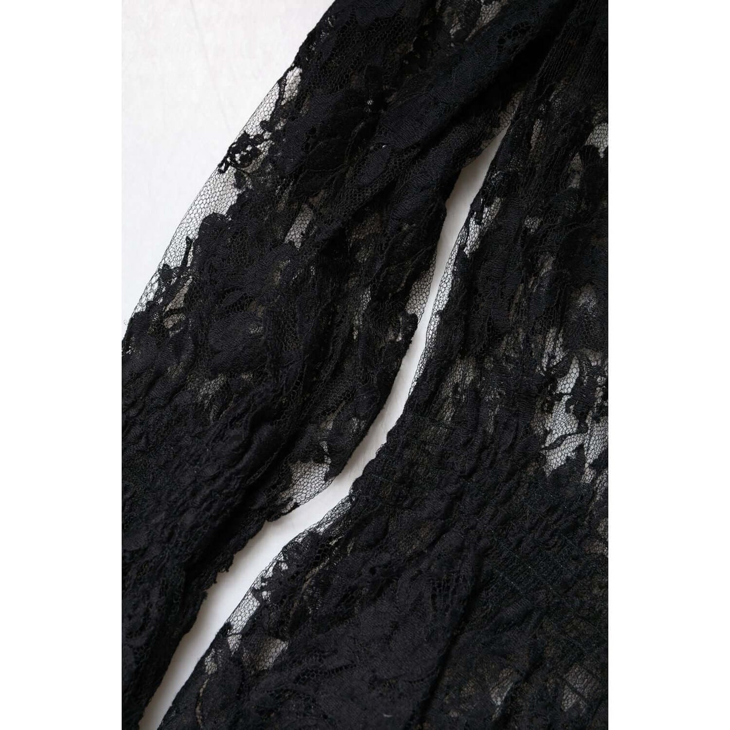 Close-up of Dolce & Gabbana black floral lace blouse, showcasing intricate craftsmanship and exclusive design details.