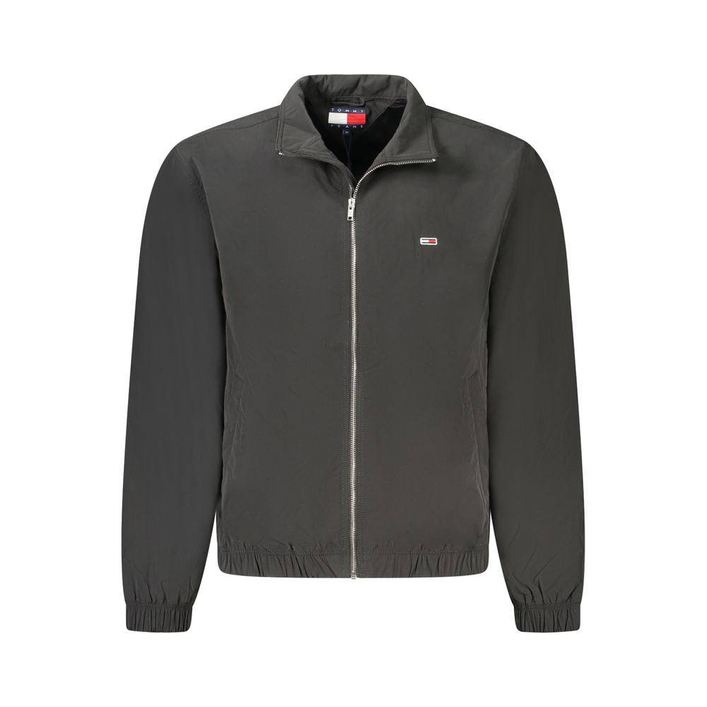 Tommy Hilfiger black polyester men’s jacket with zip-up front and iconic logo, featuring long sleeves and external pockets for sleek style.