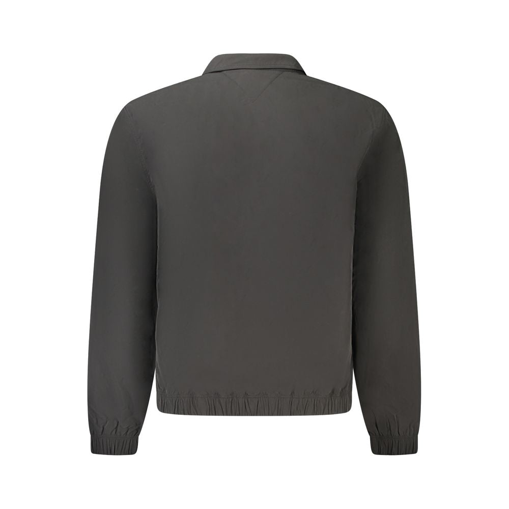 Back view of black Tommy Hilfiger men's jacket made from recycled polyester featuring long sleeves and eco-friendly design.