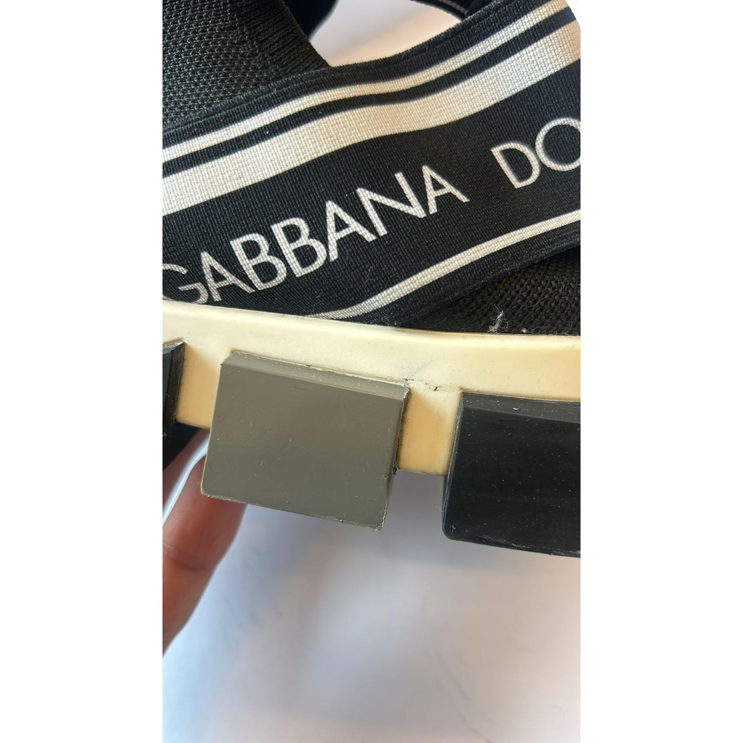Close-up of Dolce & Gabbana Black and White Sorrento Sneakers showing logo and rubber sole details.