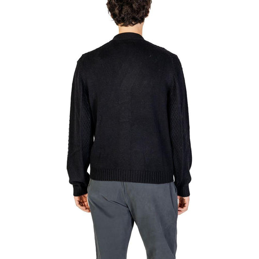 Back view of a man wearing a Hamaki-Ho black polyester cardigan, part of men's fall/winter knitwear collection.