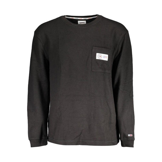 Tommy Hilfiger black cotton men's sweater with round neck and embroidered pocket detail, featuring iconic logo for style distinction.