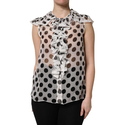 Dolce & Gabbana white sleeveless top with black polka dots, ruffle front, and button-down closure; made of silk and cotton blend.